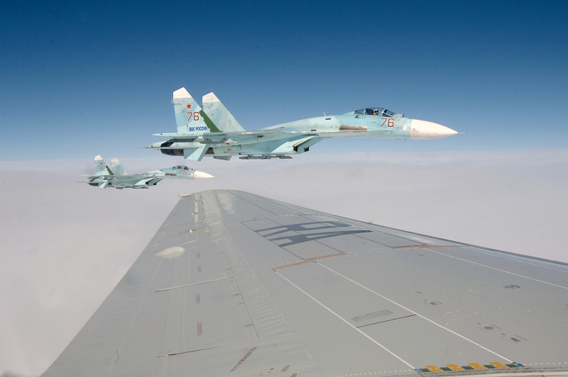 27. Joint NORAD-Russia Exercise VIGILANT EAGLE: High Above the Pacific Ocean, Two Russian Federation Air Force Su-27 Fighter Jets Intercept and Escort an Airliner During the International Hijacking Senario, August 9, 2011. Photo Credit: Tech. Sgt. Thomas J. Doscher, United States Air Force; North American Aerospace Defense Command (NORAD, http://www.norad.mil, 110809-F-YX459-164), United States Department of Defense (DoD, http://www.DefenseLink.mil or http://www.dod.gov), Government of the United States of America (USA).