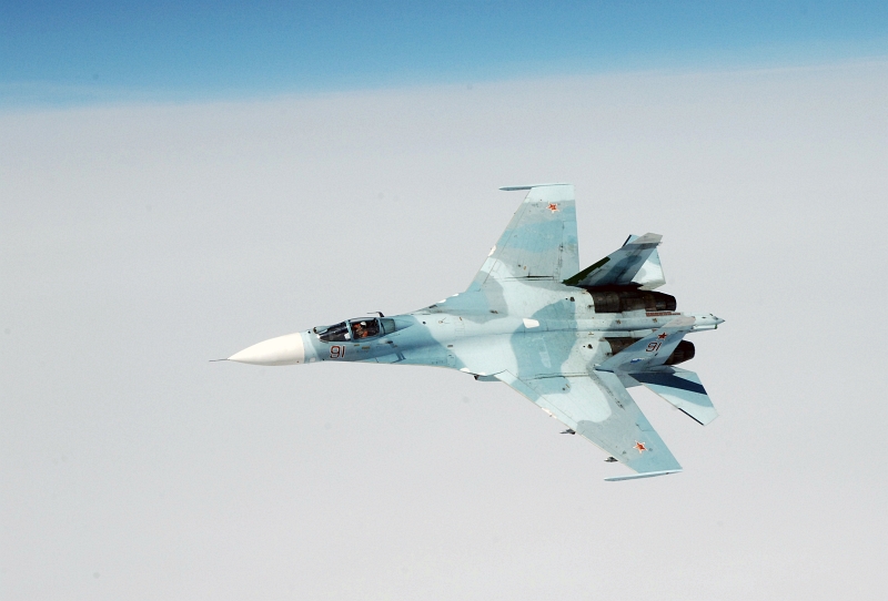 26. Joint NORAD-Russia Exercise VIGILANT EAGLE: High Above the Pacific Ocean, One Russian Federation Air Force Su-27 Fighter Jet Moves Into Position to Escort an Airliner During the International Hijacking Senario, August 9, 2011. Photo Credit: Tech. Sgt. Thomas J. Doscher, United States Air Force; North American Aerospace Defense Command (NORAD, http://www.norad.mil, 110809-F-YX459-482), United States Department of Defense (DoD, http://www.DefenseLink.mil or http://www.dod.gov), Government of the United States of America (USA).