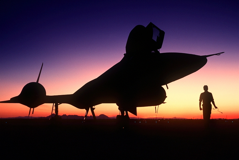 24. A U.S. Air Force SR-71 Blackbird Strategic Reconnaissance Training Aircraft Silhouetted At Sundown While Parked On the Runway, June 1, 1988, Beale Air Force Base, State of California, USA. Photo Credit: Tech. Sgt. Michael Haggerty, United States Air Force; Defense Visual Information (DVI, http://www.DefenseImagery.mil, DF-ST-89-06278) and United States Air Force (USAF, http://www.af.mil), United States Department of Defense (DoD, http://www.DefenseLink.mil or http://www.dod.gov), Government of the United States of America (USA).