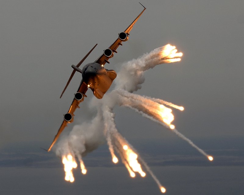 2. A United States Air Force C-17 Globemaster III Military Transport with the 14th Airlift Squadron located at Charleston Air Force Base in South Carolina fires flares over the Atlantic Ocean during a local exercise. May 16, 2006, Over the Atlantic Ocean Near Charleston, State of South Carolina, USA. Photo Credit: TSgt. Russell E. Cooley IV, United States Air Force (USAF, http://www.af.mil); Defense Visual Information Center (DVIC, http://www.DoDMedia.osd.mil, 060516-F-9712C-432) and United States Air Force (USAF, http://www.af.mil), United States Department of Defense (DoD, http://www.DefenseLink.mil or http://www.dod.gov), Government of the United States of America (USA).. C-17 Globemaster III fact sheets from the United States Air Force <http://www.af.mil/factsheets/factsheet.asp?fsID=86> and The Boeing Company <http://www.boeing.com/defense-space/military/c17/index.htm>.