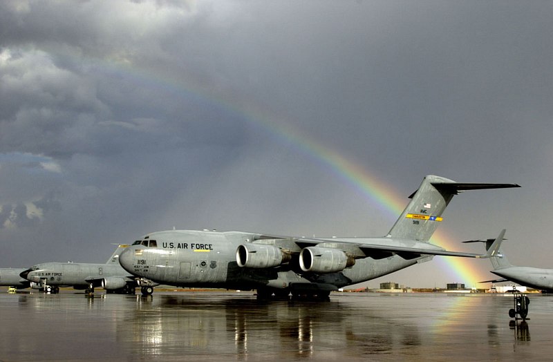 A Beautiful, Partially Very Bright Rainbow -- an Arc of Light -- Effortlessly Cuts Through a Dark Sky Full of Grey Clouds After a Sudden and Heavy Rain Shower, Arching Over the Airfield at Moron Air Base, January 2003, Reino de Espa�a - Kingdom of Spain. Photo Credit: Staff Sgt. P. J. Farlin, Air Force Link - Photos (http://www.af.mil/photos, 030128-O-9999J-023, "Rainbow After Rain"), United States Air Force (USAF, http://www.af.mil), United States Department of Defense (DoD, http://www.DefenseLink.mil or http://www.dod.gov), Government of the United States of America (USA).