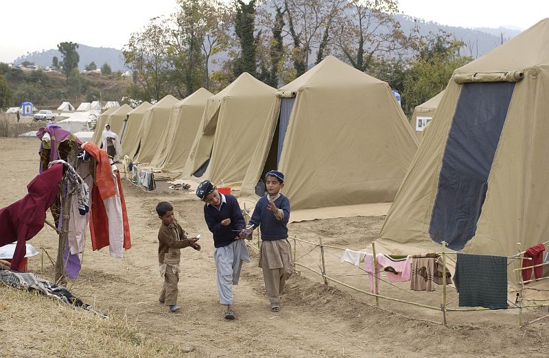 Seen here playing with a toy helicopter, these three Pakistani children lost their homes in the earthquake that shook the region on October 8, 2005. However, they still have that geninue playfulness and curiosity, naturally radiated by young children, that brings a certain cheer and hope to difficult times. November 21, 2005, Jabba Farm Tent Village, Shinkiari, Islamic Republic of Pakistan. Photo Credit: Airman 1st Class Barry Loo, United States Air Force (USAF, http://www.af.mil); Navy NewsStand - Eye on the Fleet Photo Gallery (http://www.news.navy.mil/view_photos.asp, 051121-F-2729L-001), United States Navy (USN, http://www.navy.mil), United States Department of Defense (DoD, http://www.DefenseLink.mil or http://www.dod.gov), Government of the United States of America (USA).