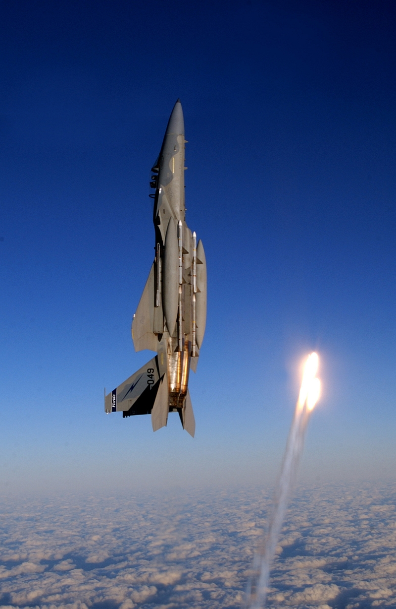 9. Vertical Above the Cloud Deck, A Florida Air National Guard F-15A Eagle Fighter Jet, Assigned to the 125th Fighter Wing, Fires Two Flares, To Get the Attention of A Civilian Aircraft Violating A Restricted Area, January 7, 2004, Jacksonville International Airport, State of Florida, USA. Photo Credit: Master Sgt. Shaun W. Withers (125th Fighter Wing, Florida Air National Guard), United States Air Force; Defense Visual Information (DVI, http://www.DefenseImagery.mil, 040107-F-TS431-053) and United States Air Force (USAF, http://www.af.mil), United States Department of Defense (DoD, http://www.DefenseLink.mil or http://www.dod.gov), Government of the United States of America (USA).