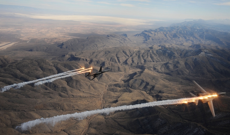 6. Two U.S. Air Force B-1B Lancer Heavy Bombers -- attached to the 28th Bomb Squadron, Dyess Air Force Base, Texas -- Fire Flares and Chaff During A Training Mission, February 24, 2010, State of New Mexico, USA. Photo Credit: Master Sgt. Kevin J. Gruenwald, United States Air Force; Defense Visual Information (DVI, http://www.DefenseImagery.mil, 100224-F-6911G-067) and United States Air Force (USAF, http://www.af.mil), United States Department of Defense (DoD, http://www.DefenseLink.mil or http://www.dod.gov), Government of the United States of America (USA).