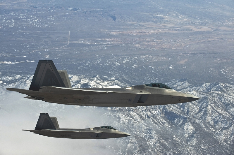 33. Two U.S. Air Force F-22A Raptor Stealth Fighter Jets Fly Above the Nevada Test and Training Range During Red Flag 11-3, March 2, 2011, State of Nevada, USA. Photo Credit: Senior Airman Brett Clashman, United States Air Force; Defense Visual Information (DVI, http://www.DefenseImagery.mil, 110302-F-KX404-046) and United States Air Force (USAF, http://www.af.mil), United States Department of Defense (DoD, http://www.DefenseLink.mil or http://www.dod.gov), Government of the United States of America (USA).