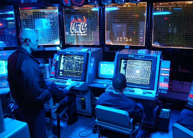 Monitoring and Watching the Sky From Inside the Carrier Air Traffic Control Center (CATCC), March 18, 2002, Aboard the Aircraft Carrier USS John F. Kennedy (CV 67), United States Navy. Photo Credit: Photographer's Mate 2nd Class Travis L. Simmons, Navy NewsStand - Eye on the Fleet Photo Gallery (http://www.news.navy.mil/view_photos.asp, 020318-N-0012S-004), United States Navy (USN, http://www.navy.mil), United States Department of Defense (DoD, http://www.DefenseLink.mil or http://www.dod.gov), Government of the United States of America (USA).