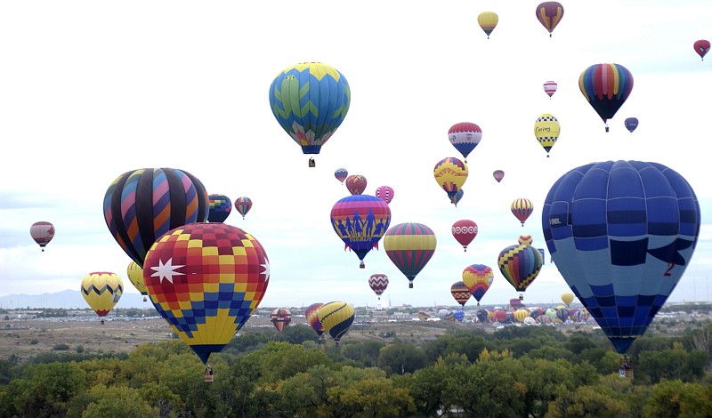 Fun, Happy, Cheerful Times at the Balloon Fiesta: Many Colorful Hot Air Balloons Rise Into the Sky Over Fiesta Park, October 7, 2006 Albuqerque, State of New Mexico, USA. Photo Credit: Staff Sgt. Lee Hoover, Air Force Link - Photos (http://www.af.mil/photos, 061006-F-0588H-039, 'Rising up'), United States Air Force (USAF, http://www.af.mil), United States Department of Defense (DoD, http://www.DefenseLink.mil or http://www.dod.gov), Government of the United States of America (USA).
