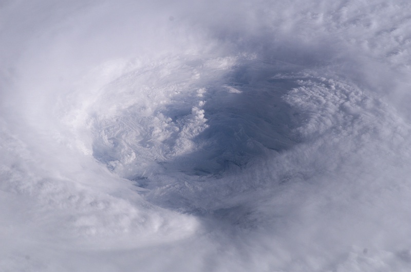 6. A Detailed Look Inside Hurricane Isabel's Cloudy Eye, Over the Atlantic Ocean on September 13, 2003 at 11:18:44.230 GMT, As Seen From the International Space Station (Expedition 7). Photo Credit: NASA Astronaut Dr. Edward Tsang Lu, Ph.D. aboard the International Space Station (Expedition Seven); ISS007-E-14745, Detailed view of Hurricane Isabel's eye, Eyewall structure, Atlantic Ocean; Image Science and Analysis Laboratory, NASA-Johnson Space Center. 'Astronaut Photography of Earth - Display Record.' <http://eol.jsc.nasa.gov/scripts/sseop/photo.pl?mission=ISS007&roll=E&frame=14745>; National Aeronautics and Space Administration (NASA, http://www.nasa.gov), Government of the United States of America (USA).