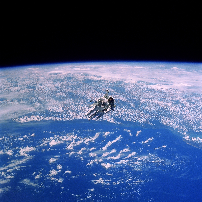21. NASA Astronaut Robert L. Stewart Floats Above Cloudy Earth During an Untethered Extravehicular Activity (EVA), February 1984, As Seen From Space Shuttle Challenger (STS-41B). Photo Credit: National Aeronautics and Space Administration (NASA, http://www.nasa.gov, STS41B-35-1659, http://eol.jsc.nasa.gov/scripts/sseop/photo.pl?mission=STS41B&roll=35&frame=1659), Space Shuttle Challenger (STS-41-B); Defense Visual Information Center (DVIC, http://www.DoDMedia.osd.mil, DF-SC-84-10569) and United States Air Force (USAF, http://www.af.mil), United States Department of Defense (DoD, http://www.DefenseLink.mil or http://www.dod.gov), Government of the United States of America (USA).