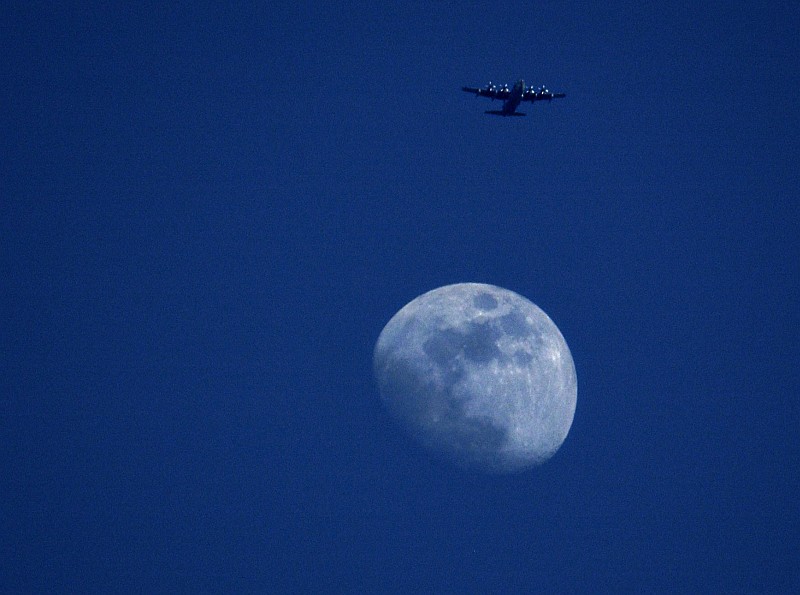 Earth's Moon in the Night Sky Forms a Beautiful Backdrop for the United States Air Force C-130 Hercules Preparing For a Parachute Drop in the Golf Drop Zone Near Camp Lemonier, November 12, 2005, Jumhuriyat Jibuti (Republique de Djibouti) - Republic of Djibouti. Photo Credit: Staff Sgt. Stacy L. Pearsall, 1st Combat Camera Squadron, United States Air Force (USAF, http://www.af.mil); DefenseLINK News Photos (http://www.DefenseLink.mil/photos/, 051112-F-7234P-197), United States Department of Defense (DoD, http://www.DefenseLink.mil or http://www.dod.gov), Government of the United States of America (USA).