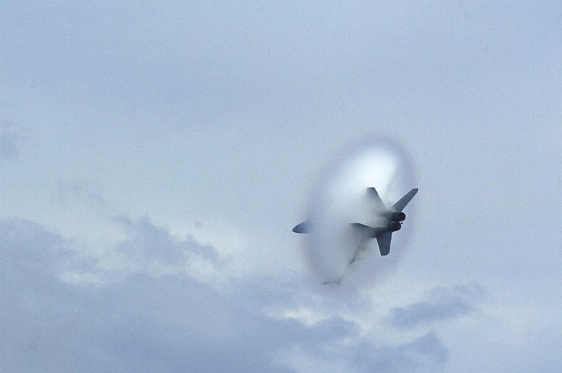 PHOTO 2. 060911-N-8604L-741 East China Sea (Sept. 11, 2006) - An F/A-18F Super Hornet assigned to Carrier Air Wing Five breaks the sound barrier during an air power demonstration practice aboard USS Kitty Hawk (CV 63). Currently underway in the 7th Fleet area of responsibility (AOR), Kitty Hawk demonstrates power projection and sea control as the U.S. Navy's only permanently forward-deployed aircraft carrier. U.S. Navy photo by Mass Communication Specialist Seaman Joshua Wayne LeGrand (RELEASED) 
