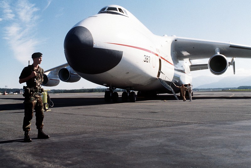 7. A United States Airman First Class (A1C) of the 21st Security Police Squadron Guards the Antonov An-225 Mriya ("Cossak"), a Heavy Transport Aircraft, As It Sits On the Flight Line, August 1989, Elmendorf Air Force Base, State of Alaska, USA. Photo Credit: SSgt. Kevin L. Bishop, United States Air Force (USAF, http://www.af.mil); Defense Visual Information Center (DVIC, http://www.DoDMedia.osd.mil, DFST9005773) and United States Air Force (USAF, http://www.af.mil), United States Department of Defense (DoD, http://www.DefenseLink.mil or http://www.dod.gov), Government of the United States of America (USA).