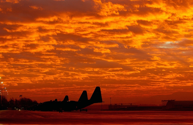 79. Fiery Sky: The Rising of the Sun on December 1, 2003, Ramstein Air Base, Landes Rheinland-Pfalz (Federal State of Rhineland-Palatinate), Bundesrepublik Deutschland - Federal Republic of Germany. Photo Credit: Tech. Sgt. (TSgt.) Justin D. Pyle, United States Air Force (USAF, http://www.af.mil); Defense Visual Information Center (DVIC, http://www.DoDMedia.osd.mil, DF-SD-06-00903 and 031201-F-6701P-001) and United States Air Force (USAF, http://www.af.mil), United States Department of Defense (DoD, http://www.DefenseLink.mil or http://www.dod.gov), Government of the United States of America (USA).