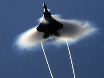 Semo (Julio) 2009, Salmo 17:8-9.  A United States Air Force F-22A Raptor Stealth Fighter Jet, With Wingtip Vortices and A Condensation Cloud, Fighter Jet Performs A High-Speed Flyby During Northern Edge 2009 on June 22, 2009, Gulf of Alaska, State of Alaska, USA. Flying at transonic speeds (flying transonically) -- speeds varying near and at the speed of sound (supersonic) -- can generate impressive condensation clouds caused by the Prandtl-Glauert Singularity. For a scientific explanation, see Professor M. S. Cramer's Gallery of Fluid Mechanics, Prandtl-Glauert Singularity at <http://www.GalleryOfFluidMechanics.com/conden/pg_sing.htm>; and Foundations of Fluid Mechanics, Navier-Stokes Equations Potential Flows: Prandtl-Glauert Similarity Laws at <http://www.Navier-Stokes.net/nspfsim.htm>. Photo Credit: Mass Communication Specialist 3rd Class Josue L. Escobosa, United States Navy (USN, http://www.navy.mil); Defense Visual Information (DVI, http://www.DefenseImagery.mil, 090622-N-9928E-216) and United States Navy (USN, http://www.navy.mil), United States Department of Defense (DoD, http://www.DefenseLink.mil or http://www.dod.gov), Government of the United States of America (USA).