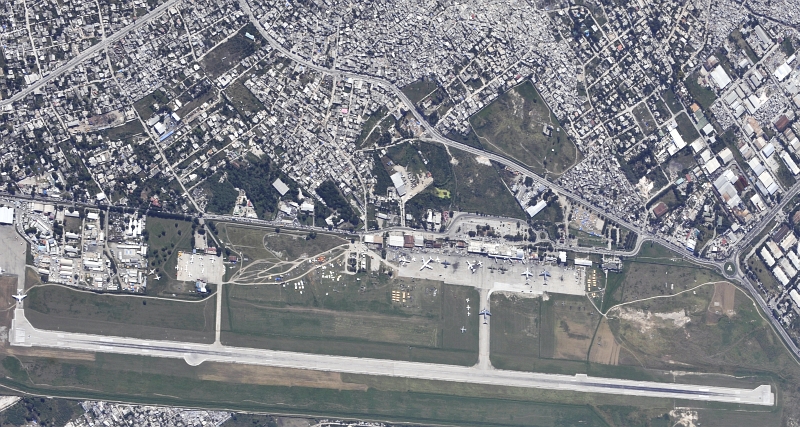 23. Aerial View of Toussaint Louverture International Airport (Aeroport International Toussaint Louverture) and the City of Port-au-Prince, January 16, 2010, Republique d'Haiti (Repiblik d' Ayiti) - Republic of Haiti, As Seen From A U.S. Air Force OC-135B Open Skies Observation Aircraft. Photo Credit: Airman 1st Class (A1C) Perry Aston, United States Air Force; Defense Visual Information (DVI, http://www.DefenseImagery.mil, 100116-F-6188A-030) and United States Air Force (USAF, http://www.af.mil), United States Department of Defense (DoD, http://www.DefenseLink.mil or http://www.dod.gov), Government of the United States of America (USA).