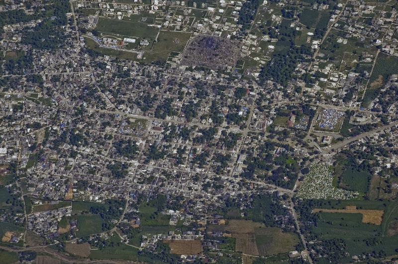 33. Tent Camps, With Makeshift Shelters, Constructed By Earthquake Survivors and Earthquake-Damaged Buildings, January 16, 2010, Republique d'Haiti (Repiblik d' Ayiti) - Republic of Haiti, As Seen From A U.S. Air Force OC-135B Open Skies Observation Aircraft. Photo Credit: Airman 1st Class (A1C) Perry Aston, United States Air Force; Defense Visual Information (DVI, http://www.DefenseImagery.mil, 100116-F-6188A-362) and United States Air Force (USAF, http://www.af.mil), United States Department of Defense (DoD, http://www.DefenseLink.mil or http://www.dod.gov), Government of the United States of America (USA).