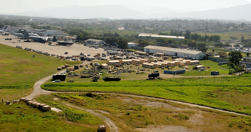 27. Tents, Military Equipment, Supplies, Military Aircraft, Civilian Aircraft At Toussaint Louverture International Airport (Aeroport International Toussaint Louverture), January 18, 2010, Port-au-Prince, Republique d'Haiti (Repiblik d' Ayiti) - Republic of Haiti. Photo Credit: Technical Sgt. (TSgt) James L. Harper Jr., United States Air Force; Defense Visual Information (DVI, http://www.DefenseImagery.mil, 100118-F-4177H-134) and United States Air Force (USAF, http://www.af.mil), United States Department of Defense (DoD, http://www.DefenseLink.mil or http://www.dod.gov), Government of the United States of America (USA).