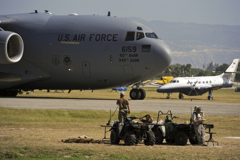 50. U.S. Air Force Combat Controllers (From the 23rd Special Tactics Squadron at Hurlburt Field, Florida, USA) -- U.S. Air Force Special Operations Air Traffic Controllers -- Guide A USAF C-17 Globemaster III Cargo Aircraft At Toussaint Louverture International Airport, January 23, 2010, Republique d'Haiti (Repiblik d' Ayiti) - Republic of Haiti. Photo Credit: Staff Sgt. Desiree N. Palacios, Air Force Link (AFLink) Photos (http://www.af.mil/photos, 100123-F-1830P-381, 'Combat controllers at work'), United States Air Force (USAF, http://www.af.mil), United States Department of Defense (DoD, http://www.DefenseLink.mil or http://www.dod.gov), Government of the United States of America (USA).