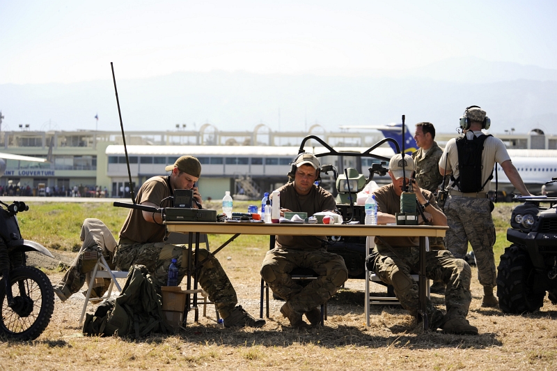 52. Busy U.S. Air Force Combat Controllers (From the 23rd Special Tactics Squadron at Hurlburt Field, Florida, USA) -- They're U.S. Air Force Special Operations Air Traffic Controllers -- Talk To Aircraft Circling Toussaint Louverture International Airport, January 23, 2010, Republique d'Haiti (Repiblik d' Ayiti) - Republic of Haiti. Photo Credit: Staff Sgt. Desiree N. Palacios, Air Force Link (AFLink) Photos (http://www.af.mil/photos, 100123-F-1830P-387, 'Combat controllers at work'), United States Air Force (USAF, http://www.af.mil), United States Department of Defense (DoD, http://www.DefenseLink.mil or http://www.dod.gov), Government of the United States of America (USA).