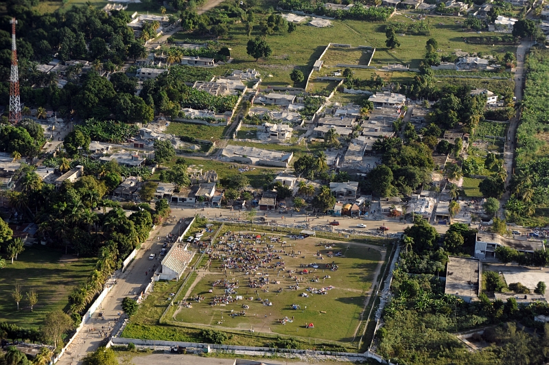 1. January 13, 2010: Aerial view of the survivors gathering an a field and the destruction caused by the 7.0 magnitude earthquake in Republique d'Haiti (Repiblik d' Ayiti) - Republic of Haiti on January 12, 2010. Photo Credit: Petty Officer 2nd Class Sondra-Kay Kneen, United States Coast Guard (USCG, http://www.uscg.mil) Visual Information Gallery (http://cgvi.uscg.mil/media/main.php, 100113-G-7070K-002), United States Department of Homeland Security (DHS, http://www.dhs.gov), Government of the United States of America (USA).