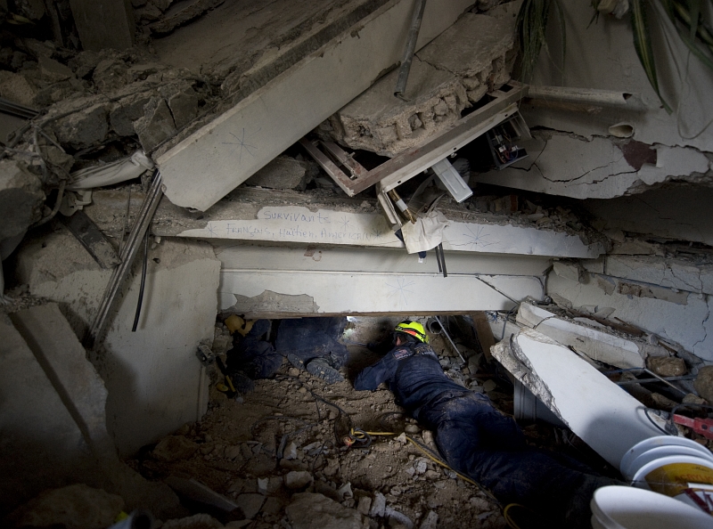 12. The Search For Survivors: Members of Members of Virginia Task Force 1 (VATF-1), Fairfax County's Urban Search and Rescue Team,  Conduct A Rescue Operation At the Hotel Montana, January 14, 2010, Port-au-Prince, Republique d'Haiti (Repiblik d' Ayiti) - Republic of Haiti. Photo Credit: Mass Communication Specialist 1st Class Joshua Lee Kelsey, United States Navy; Defense Visual Information (DVI, http://www.DefenseImagery.mil, 100114-N-6266K-136) and United States Navy (USN, http://www.navy.mil), United States Department of Defense (DoD, http://www.DefenseLink.mil or http://www.dod.gov), Government of the United States of America (USA).