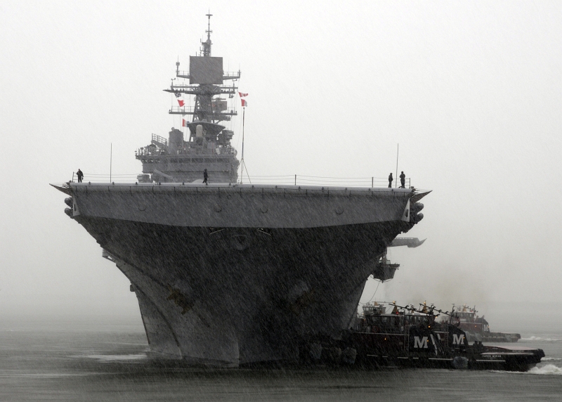 1. The Amphibious Assault Ship USS Bataan (LHD 5) -- In the Rain and Accompanied By Two Tugboats -- Returns to Naval Station Norfolk, May 23, 2013, Commonwealth of Virginia, USA. Photo Credit: Mass Communication Specialist 1st Class Phil Beaufort, Photo Gallery (http://www.navy.mil/viewGallery.asp, 130523-N-ZO696-004), United States Navy (USN, http://www.navy.mil), United States Department of Defense (DoD, http://www.DefenseLink.mil or http://www.dod.gov), Government of the United States of America (USA).