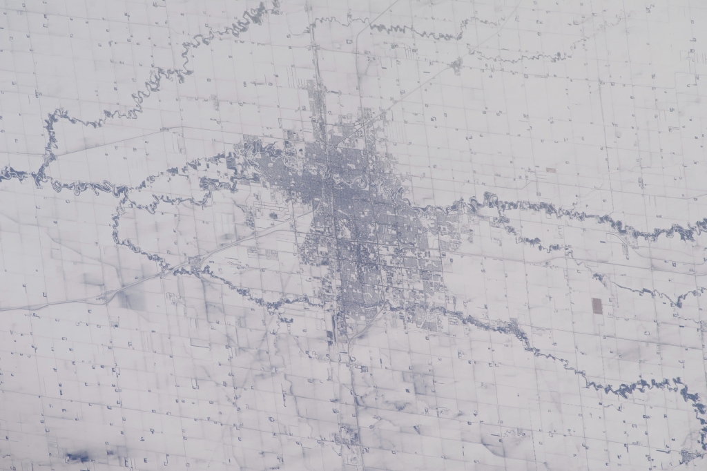 3. A City, Land, and Rivers, February 18, 2014 at 21:31:01 GMT, As Seen From the International Space Station (Expedition 38) While Orbiting Above State of Minnesota, USA, Latitude (LAT): 45.1, Longitude (LON): -93.4, Altitude (ALT): 221 Nautical Miles, Sun Azimuth (AZI): 229 degrees, Sun Elevation Angle (ELEV): 20 degrees. Photo Credit: NASA; ISS038-E-51544, International Space Station (Expedition 38); Image Science and Analysis Laboratory, NASA-Johnson Space Center. "The Gateway to Astronaut Photography of Earth." <http://eol.jsc.nasa.gov/scripts/sseop/photo.pl?mission=ISS038&roll=E&frame=51544>; National Aeronautics and Space Administration (NASA, http://www.nasa.gov), Government of the United States of America (USA).